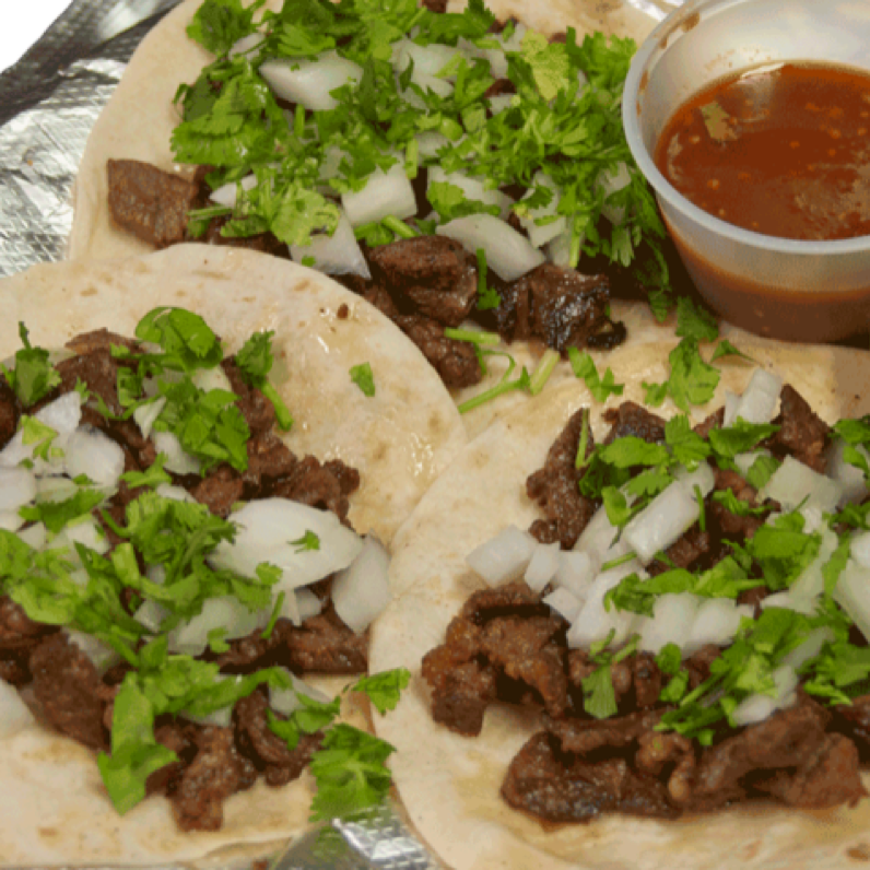 Mexican platter featuring cheese dip, corn, quesadillas, and chips.